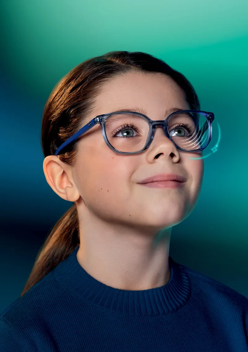 Essilor Stellest 2.0 Lenses, child wearing spectacles with the lens's lenslet rings illustrated on one lens