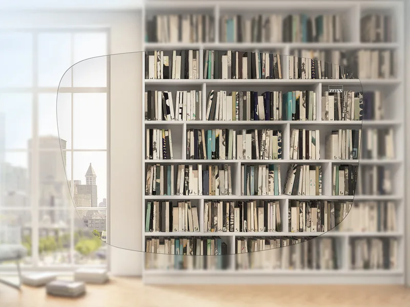 ZEISS Single Vision Individual Clear Lenses, simulated view of a bookshelf and window through a clear ZEISS Single Vision Individual lens