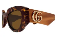 Gucci GG1421S sunglasses in havana (009), close-up of the gold GG logo on the honey temple